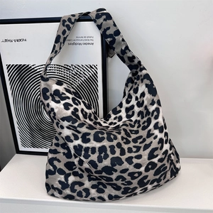 Detail of trendy leopard print tote bag with wide shoulder strap in canvas material