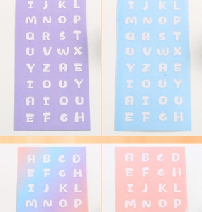 Detail of colorful alphabet sticker sheets in purple, blue, and pink for DIY scrapbooks