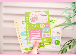 Detail of colorful paper stickers featuring monthly calendars and to-do lists for journaling