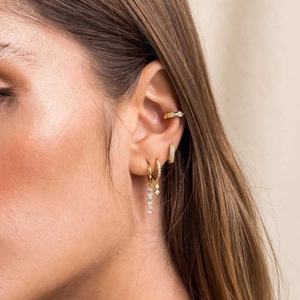 Gold geometric hoop earrings set with zircon studs shown on model for a luxury look
