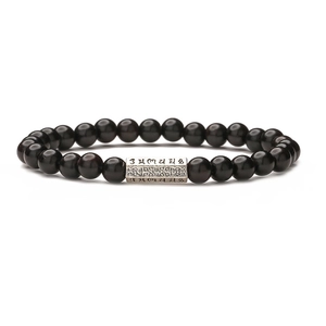 Bracelet ethnique en perles de pierre noire avec breloque cylindre argentée gravée