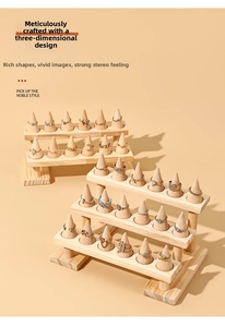 Macro detail of multi-tier wooden ring display stand with natural finish ring cones