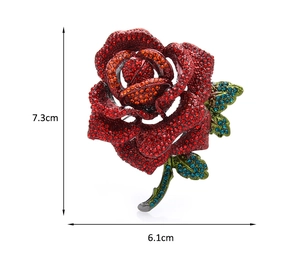 Detail of rose brooch with red and orange rhinestones, dimensions 7.3cm by 6.1cm