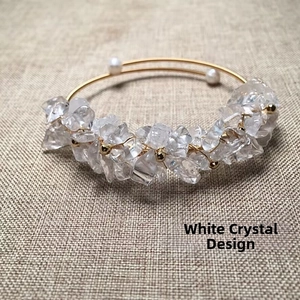 Detail of 14K gold wire hand-wrapped open bangle with white crystal and freshwater pearl