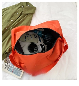 Internal capacity of the orange sports gym bag showing storage for daily essentials