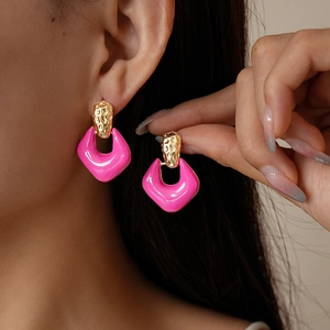 Retro geometric enamel earrings in vibrant pink and gold finish with hammered texture
