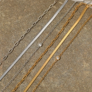 Multilayered gold and silver stainless steel chain bracelets with zircon on stone