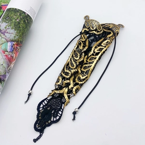 Detailed embroidery of black and gold lace armlet with Gothic Baroque floral patterns