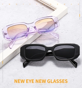 Close-up of retro square sunglasses in purple and black with wide temples on gray texture