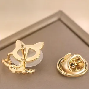 Golden cat brooch with sparkling crystals and polished finish showing front and back view
