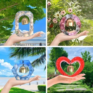 Handmade resin wind chimes in hexagon and heart shapes with metal bells and shells