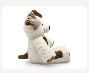 Detail of curly plush texture on a cute white puppy doll with brown spots and soft fur