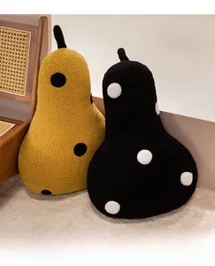 Detail of pear-shaped polka dot pillows in yellow and black cozy sherpa fabric