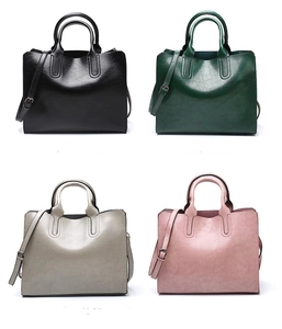 Four faux leather tote bags in black, green, grey, and pink colors with long straps