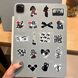 Y2K black and white stickers shown applied on a tablet case in a lifestyle setting