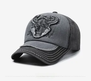 Detail view of vintage washed baseball cap with steer skull embroidery and distressed brim
