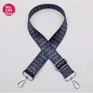 Detail of adjustable polyester strap featuring navy blue ethnic geometric patterns