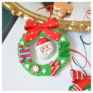 Detailed Christmas wreath ornament with Santa Claus face and a red polka dot bow