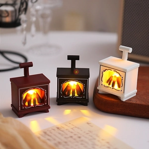 Three mini vintage LED fireplaces in red black and white colors on a wooden tray