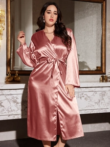 Detailed view of women's silk bathrobe with waist tie and elegant floral pattern