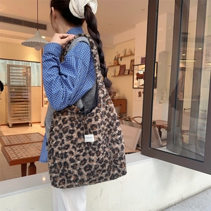 Chic leopard print faux fur tote bag showing oversized fit and soft plush texture on shoulder