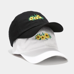 Black and white baseball caps with sunflower embroidery in a vertical stack layout