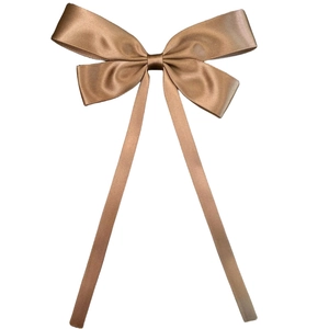 Detailed view of bronze satin ribbon hair bow with smooth texture and glossy finish