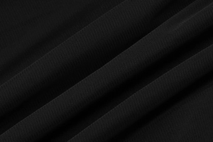 Gros plan détaillé de la texture du tissu en maille noire pour une robe moulante