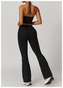 Rear view of black halter backless sports top and high waist flared yoga pants set
