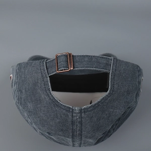 Detail of vintage washed grey baseball cap with adjustable antique bronze metal buckle