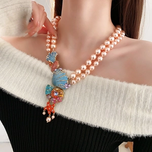 Detail of pink double-layer pearl necklace with colorful starfish shell pendant