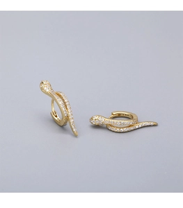 Macro shot of gold-plated snake hoop earrings with pavé set white zircon stones