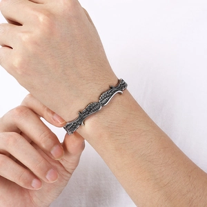 Makroaufnahme des Vintage-Silberfedermusters auf dem Edelstahl-Manschettenarmband