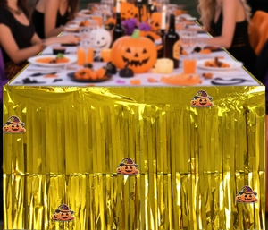 Golden foil fringe table skirt with cartoon pumpkin cutouts for Halloween party decor