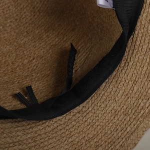 Detail view of the adjustable sweatband and woven straw texture inside the sun hat