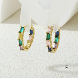 Macro shot of 18K gold plated hoop earrings featuring colorful rectangular cubic zirconia