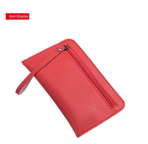 Detail of red leather long clutch bag with front zipper pocket and wrist strap