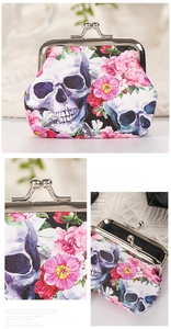 Detail view of floral skull pattern on synthetic leather coin purse with metal clasp