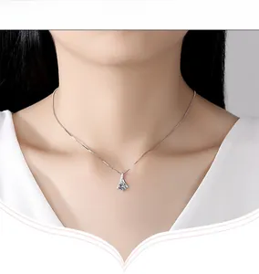 Detail of S925 silver necklace with drop-shaped cubic zirconia pendant on neck