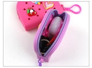 Internal view of silicone coin purse in purple and pink showing keys and earbuds storage