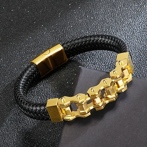 Braided black leather men's bracelet featuring a golden mechanical gear style metal plate