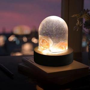 Macro view of rose resin lamp in semi-cylindrical glass dome with warm LED glow