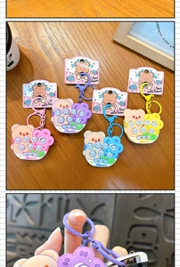 Detailed view of four colorful cute bear whack-a-mole mini game console keychains
