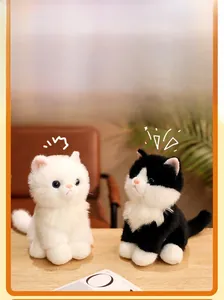 Detail of plush sitting white and cow cats with fluffy texture and blue eyes