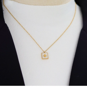 Detail of a square vintage rose necklace with white shell inlay in 18K gold plated steel
