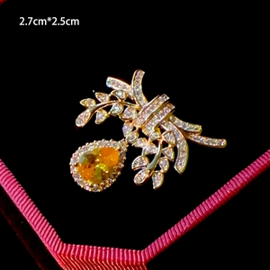 Detail view of flower brooch with micro-paved zircons and yellow teardrop gem, 2.7x2.5cm