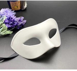 Detailed side view of a white masquerade half-face mask with black satin ribbon ties