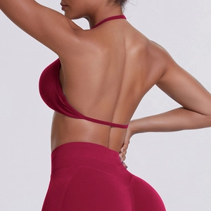 Detail view of the seamless ribbed wine red backless sports bra with halter neck design