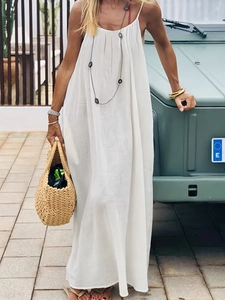 Close-up of white spaghetti strap loose maxi dress with pleated texture for summer vacation