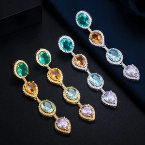 Macro view of crystal teardrop earrings featuring multi-color stones and zircon pavé